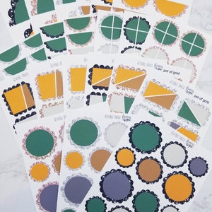 May include: A set of planner stickers featuring various shapes and sizes. The stickers are in shades of green, gold, brown, gray, and white. The stickers have a glitter finish and are decorated with black scalloped edges. The stickers are labeled "Beyond Paper Planners" and "pot of gold".