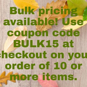 May include: A light brown wood-grain background decorated with scattered autumn leaves in shades of yellow, orange, green, and red. The text in dark green reads: Bulk pricing available! Use coupon code BULK15 at checkout on your order of 10 or more items.