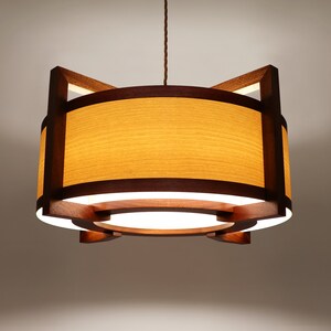 Ceiling lamp from natural wood. With diffuser at bottom.