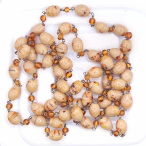 Fabulous long glass dark cream coloured bead Art Deco necklace. The beads were most probably made in Murano Italy. In fabulous condition with no damage that I can see.
42" long