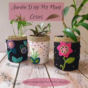May include: Three crocheted pot plant cosies, one black with a pink flower, one white with a green flower, and one black with a blue and purple flower. The cosies are labeled "Clematis", "Foxtail", and "Morning Glory". The text "Jardin D'été Pot Plant Cosies" and "pattern designed by Red Haired Amazona" are also visible.
