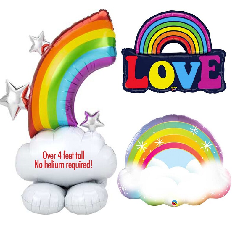 May include: Three rainbow balloon decorations. The first is a large rainbow arch with stars and clouds, over 4 feet tall. The second is a rainbow arch with the word "LOVE" in colorful letters. The third is a smaller rainbow arch with clouds and stars.