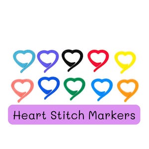 May include: A collection of ten heart-shaped stitch markers in various colors, including blue, purple, black, red, yellow, coral, green, and orange. The markers are arranged on a white background, with the text "Heart Stitch Markers" below.