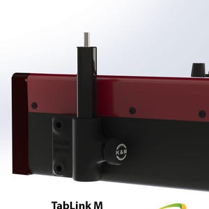 May include: Black TabLink M monitor mount with a red base and a silver knob. The mount is designed to attach to a keyboard or other musical instrument.