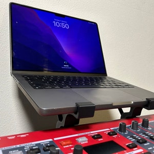 With a 14 inch MacBook Pro 2021. Fits most laptops, and you can position it across the width of your keyboard. NO drilling required!