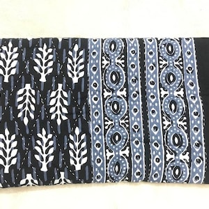 May include: Black and white cotton quilt with a geometric pattern in shades of blue. The quilt features a repeating design of leaves and circles.