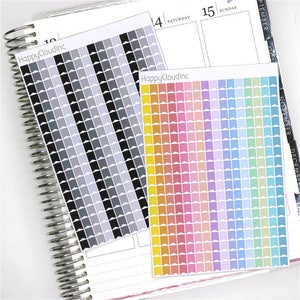 May include: Two sheets of colourful planner stickers with a variety of colours and patterns. The stickers are in the shape of small flags. The first sheet has a black and grey colour scheme. The second sheet has a rainbow colour scheme. The text "HappyCloudInc" is printed on both sheets.