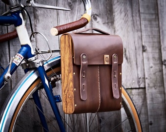 Flight bag , cycle bag, bicycle bag. Vegtanned leather , wood, Adjustable Webbing Shoulder Strap and brass hardware.