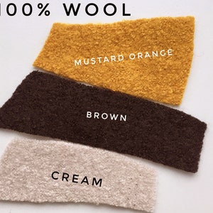 May include: Three fabric swatches of 100% wool in cream, brown, and mustard orange.