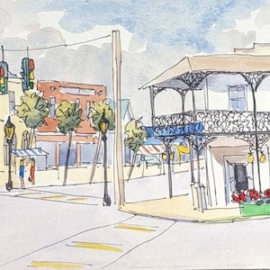 May include: Watercolor painting of a street scene with buildings, trees, and streetlights. The buildings are painted in shades of yellow, white, and brown. The trees are green and the streetlights are black. The painting is done in a realistic style.