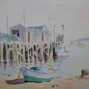 May include: A watercolor painting of a small boat docked at a pier. The boat is white with a green stripe and is tied to the pier with a rope. The pier is made of wood and has a building on it. The building is gray and has red windows. The water is blue and there are other boats in the distance.