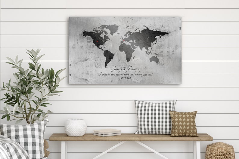 May include: A black and white world map print on a gray textured canvas with the text "James & Lauren I exist in two places, here and where you are. est. 2010".