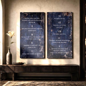 May include: Two rectangular wall art panels featuring a dark blue, textured background with rust-colored accents. The panels display the Ten Commandments in white text, numbered I through X, with five commandments listed on each vertical panel.