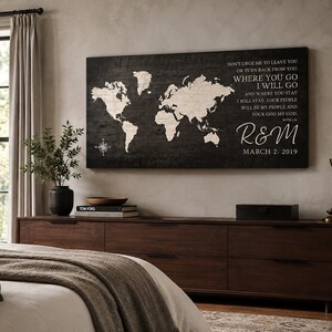 May include: A rectangular wall art piece featuring a world map in cream on a dark wood-grain background. The text reads: DON'T URGE ME TO LEAVE YOU OR TURN BACK FROM YOU. WHERE YOU GO I WILL GO AND WHERE YOU STAY I WILL STAY. R&M MARCH 2. 2019.