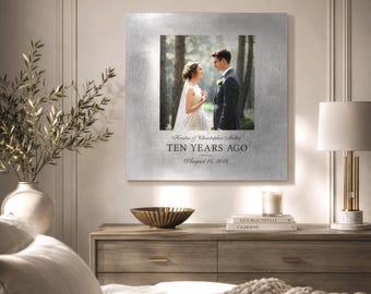May include: A square metal wall art piece featuring a centered photograph of a couple in a forest setting. Below the image, the text reads: Kristin & Christopher Miller, TEN YEARS AGO, August 14, 2016. The background of the plaque is a brushed silver.