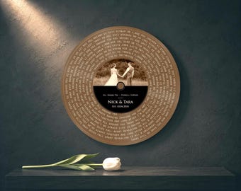 May include: A circular wall art piece designed like a vinyl record featuring a sepia-toned photograph of a couple, the text "NICK & TARA EST. 10.04.2018", "ALL AROUND YOU - STURGILL SIMPSON", and lyrics printed in a circular pattern around the edge.