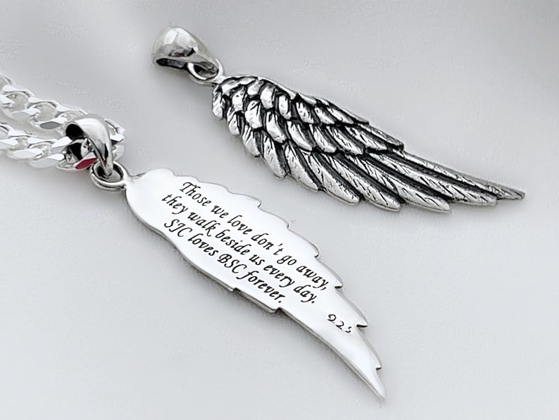 May include: Silver pendant necklace with a wing design. The pendant has an inscription that reads "Those we love don't go away, they walk beside us every day. SIC loves BSC forever. 225"