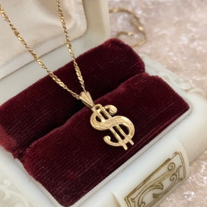 Colgante de símbolo de dólar en oro amarillo de 14 quilates y collar con cadena Singapur de oro de 14 quilates