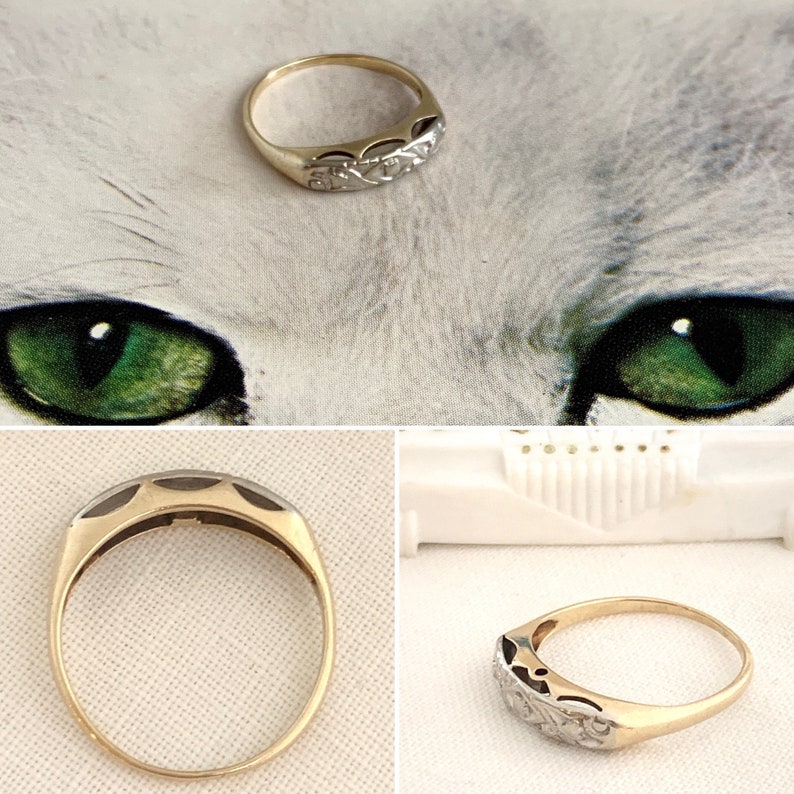 May include: A gold and silver ring with a delicate, intricate design. The ring is set with small, round stones.