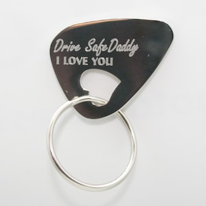 May include: Silver guitar pick keychain with the text "Drive Safe Daddy I Love You" engraved on it.