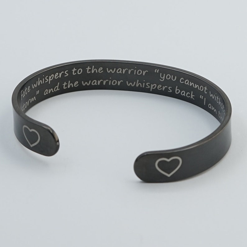 Encouragement Bracelet Fate whispers to the warrior you cannot withstand the storm the warrior whispers back I am the storm Cuff Bangle Black With Heart Out