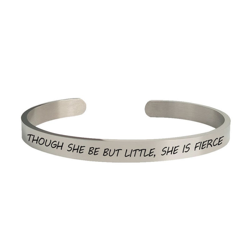 May include: Silver bangle bracelet with the inscription "Though she be but little, she is fierce."