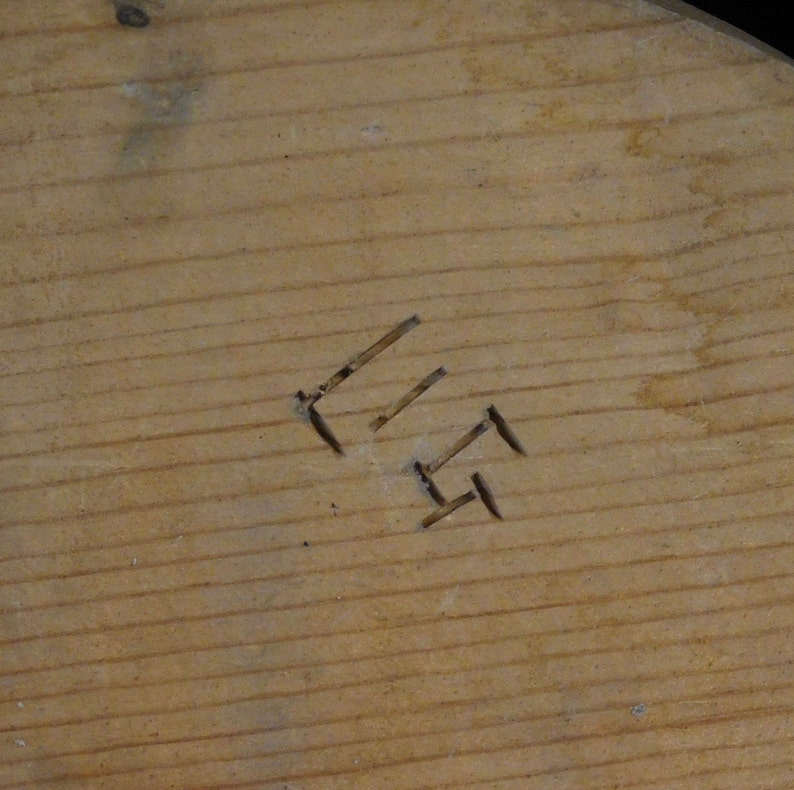 May include: Close-up of a wooden surface with the number "11" carved into it.