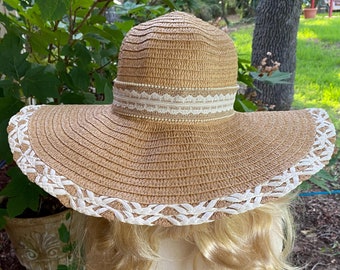 Hatt med slappkant för sol och strand. Vacker halmvävd hatt med vävd vit halmkant och ett hattband i spets, säckväv och pärlor. Unik!