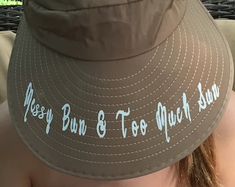 Beige Visor Foldable Hat with Pretty White Flowers Rhinestones and Studs. Monogrammed with "Messy Bun & Too Much Sun"