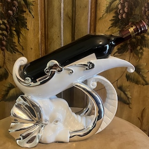 White and Silver Elephant Head wine holder very elegant. Gift for 25th silver wedding anniversary. Would be a beautiful decor for any bar.