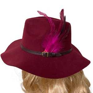 Felt Wide Brim Fedora with a Brown Leather Band with Gold Buckle Embellished with Feathers Comes in  Burgandy