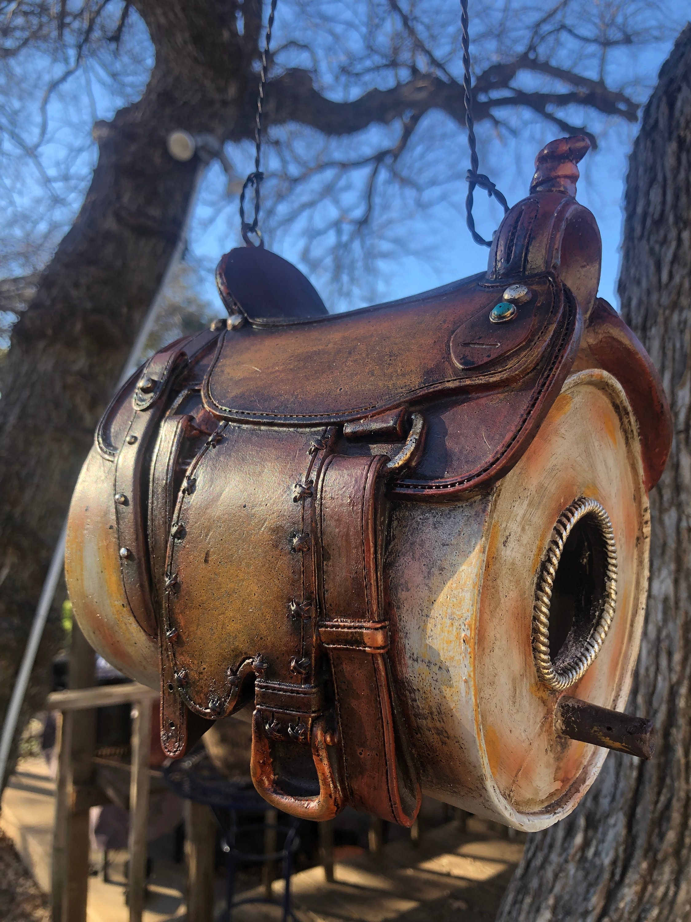 Unique saddle birdhouse sitting on a barrel. Great for anyone who remembers riding on their first saddle while strapped to a barrel.