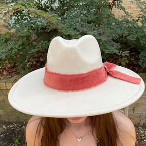 Wide Brim Felt Fedora Hat. Beautiful Beige with Orange Hat Fringed Band Accented with a Silver Medallion.