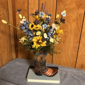 Brown boot with beautiful look of tooled leather and pumpjack, Arrangement of sunflowers, bluebonnets & greenery. Large quantities available