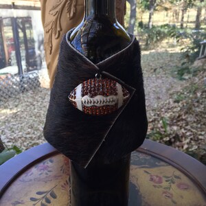 Wine Bottle Wrap/Cover/Cozy Made of Cowhide with a Football Medallion of Brown Rhinestones.  Great Gift for Football and Wine Lover.