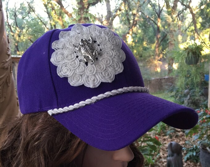 Purple Baseball Cap With Horned Frog Pin on a White Flower Made of ...