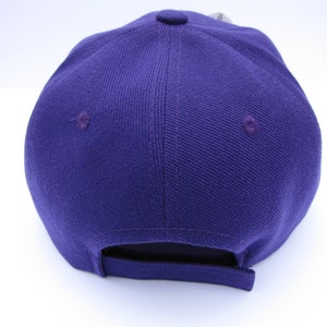 Purple Baseball Cap With Horned Frog Pin on a White Flower Made of ...