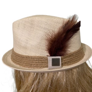 Beige Fedora with Rope Hat Band and Square Medallion Embellished with Feathers on the Side of the Hat Band