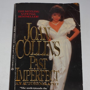 May include: A book cover with a black background and gold lettering. The title is "Joan Collins Past Imperfect An Autobiography". The cover features a photo of Joan Collins in a white dress with a white background.