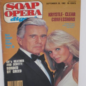 May include: A vintage "Soap Opera Digest" magazine cover featuring a man in a tuxedo and a woman in a white dress. The magazine title is in red and blue. Text includes "Krystle- Clear Confessions" and "GH's Heather and Scotty: Bonded by Greed."