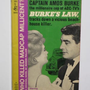 May include: A vintage paperback book cover featuring a photo of Gene Barry, the star of the television show "Burke's Law". The cover is pink, yellow, and green with the title "Who Killed Madcap Millicent?" and the text "Captain Amos Burke, the millionaire cop of ABC-TV's Burke's Law, tracks down a vicious beach-house killer."