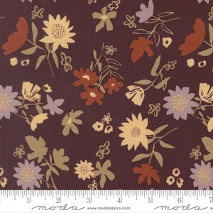 May include: A dark maroon fabric featuring a repeating pattern of stylized flowers and leaves in shades of cream, light purple, and burnt orange. A white ruler is visible at the bottom, showing measurements in inches up to 7 inches.