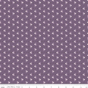 May include: Purple fabric with a repeating pattern of small white flowers and black dots. The fabric is measured in inches.