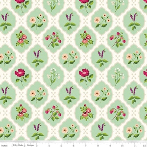 May include: A repeating pattern of floral designs on a fabric. The design features various flowers, including pink roses, white blossoms, and purple sprigs, set against a light green backdrop within a white quatrefoil shape. The fabric is measured in inches.