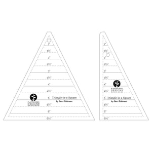 May include: Two clear acrylic quilting templates, labeled "Triangle-in-a-Square" by Gerri Robinson. The templates are triangular with measurements from 1" to 6.5" and 1.5" to 6.5". The "Planted Seed Designs" logo is visible.