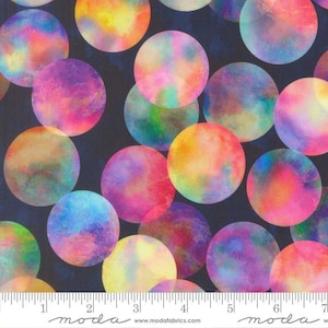 May include: A fabric pattern featuring a dark background covered in multicolored watercolor circles. The circles display gradients of pink, yellow, blue, and purple. A white ruler at the bottom shows 7 inches of length with the text moda.