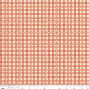 May include: A fabric swatch featuring a repeating orange and white gingham check pattern. A white ruler is visible at the bottom edge, showing a scale of 12 inches. The textile displays a consistent grid design with intersecting lines.