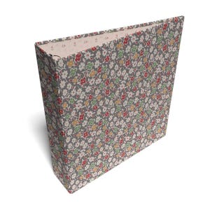 May include: A three-ring binder featuring a gray background covered in a dense, repeating pattern of small white, red, yellow, and green flowers. The interior lining of the binder is a light cream color with a subtle, tiny floral print pattern.