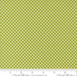 May include: Green and white gingham fabric with a small checkered pattern. The fabric is shown with a ruler for scale.