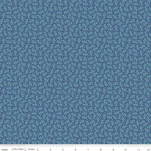 May include: A blue fabric with a repeating pattern of small teal green leaves and white dots.